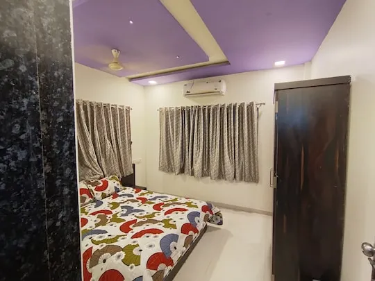 Garden Retreat — a king bedroom at PN Nature's Paradise Villa, Igatpuri