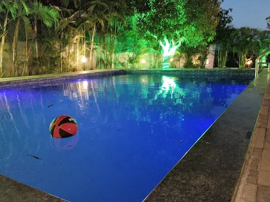 Blue light on the water at night — PN Nature's Paradise Villa, Igatpuri