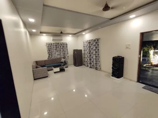 Warm-lit indoor lounge at PN Nature's Paradise Villa, Igatpuri