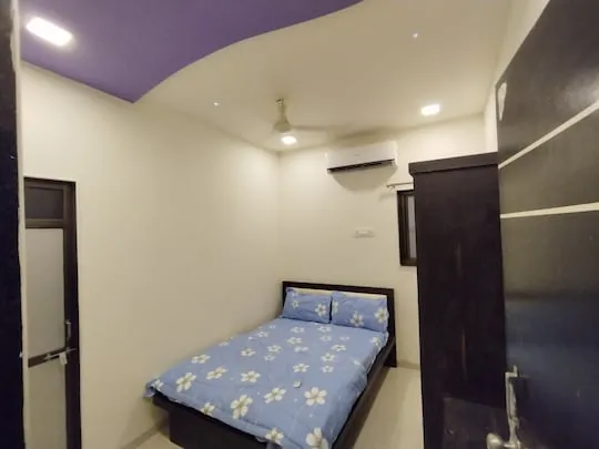 Hilltop Haven — a king bedroom at PN Nature's Paradise Villa, Igatpuri